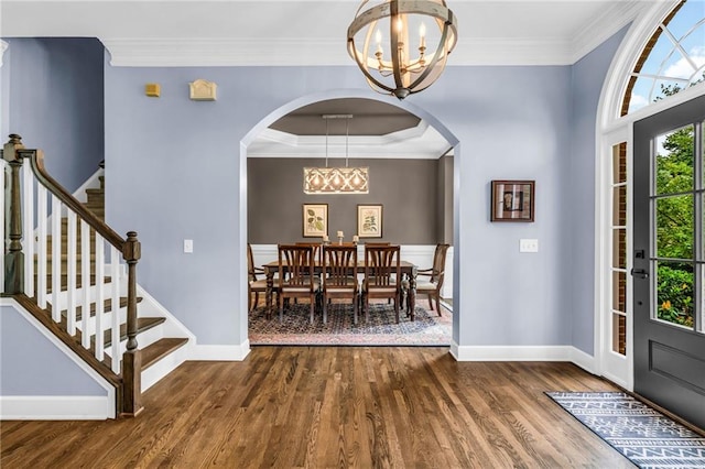 4020 Devereux Chase, Roswell, GA 30075 - dining space with a chandelier, baseboards, dark wood finished floors, crown molding, and stairs