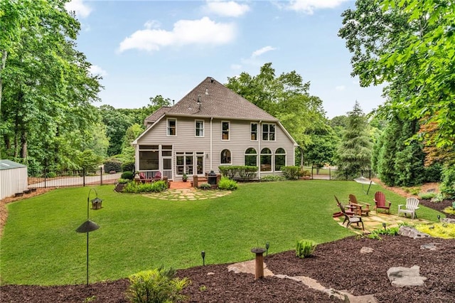 4020 Devereux Chase, Roswell, GA 30075 - back of house featuring a patio, a sunroom, and roof with shingles