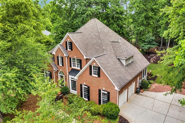 4020 Devereux Chase, Roswell, GA 30075 - view of front facade with driveway, a garage, brick siding, and roof with shingles
