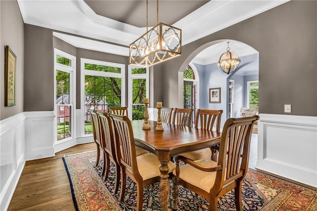 4020 Devereux Chase, Roswell, GA 30075 - dining space featuring a chandelier, healthy amount of natural light, wood finished floors, arched walkways, and ornamental molding