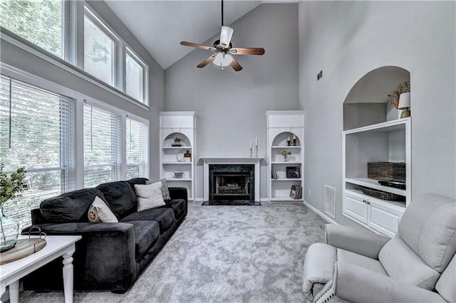 6520 Fairfield Trce, Suwanee, GA 30024 - living room with high vaulted ceiling, a ceiling fan, built in shelves, carpet, and a high end fireplace