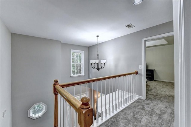 6520 Fairfield Trce, Suwanee, GA 30024 - hallway with a chandelier, carpet, and an upstairs landing