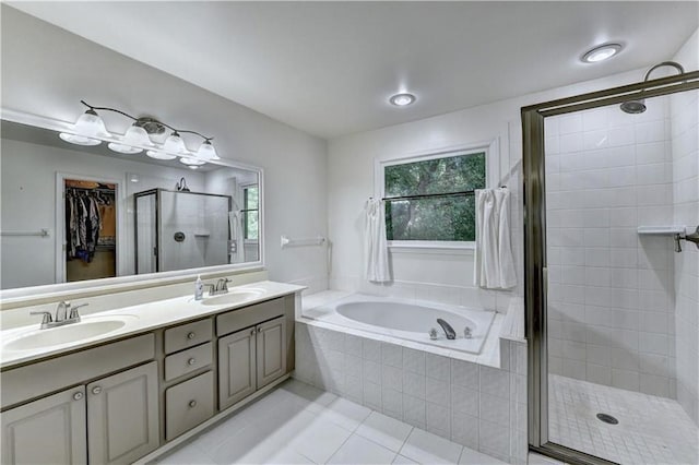 6520 Fairfield Trce, Suwanee, GA 30024 - bathroom featuring a shower stall, tile patterned floors, a bath, double vanity, and a spacious closet