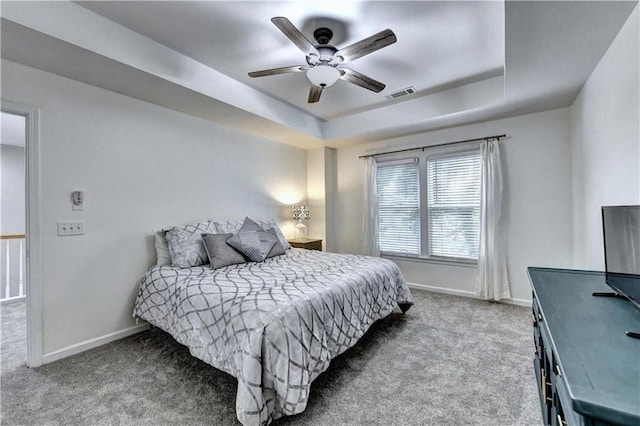 6520 Fairfield Trce, Suwanee, GA 30024 - carpeted bedroom featuring a raised ceiling and a ceiling fan