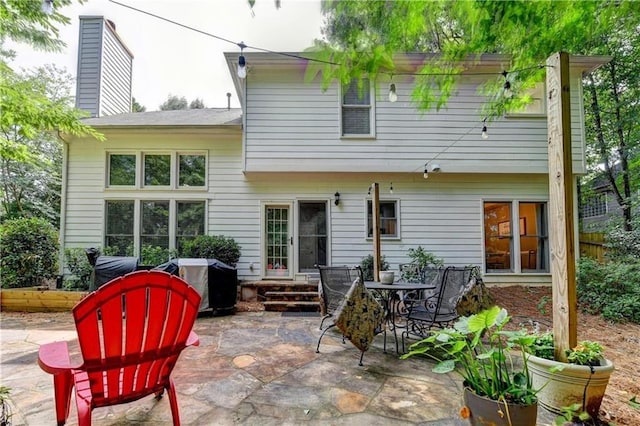 6520 Fairfield Trce, Suwanee, GA 30024 - back of property with a patio area and a chimney