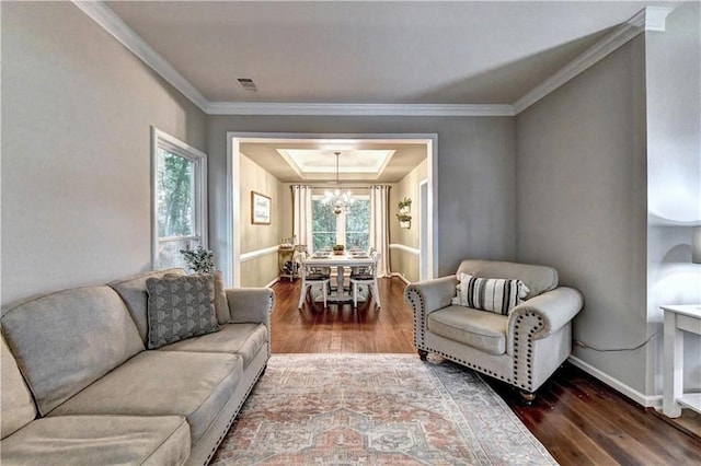 6520 Fairfield Trce, Suwanee, GA 30024 - living room with hardwood / wood-style flooring, ornamental molding, a tray ceiling, and a chandelier