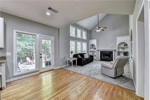 6520 Fairfield Trce, Suwanee, GA 30024 - living room with a ceiling fan, light wood-style flooring, high vaulted ceiling, a fireplace, and built in features