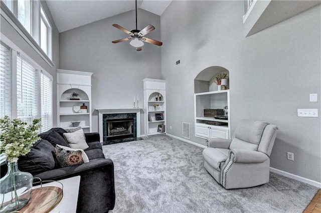 6520 Fairfield Trce, Suwanee, GA 30024 - living area featuring high vaulted ceiling, built in features, a ceiling fan, and a high end fireplace