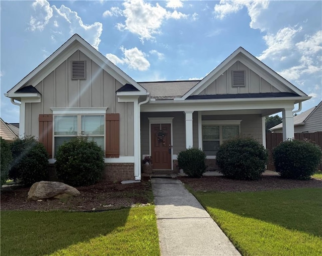 2979 Dungeness Dr, Douglasville, GA 30135 - view of front of property with board and batten siding, a front yard, and covered porch