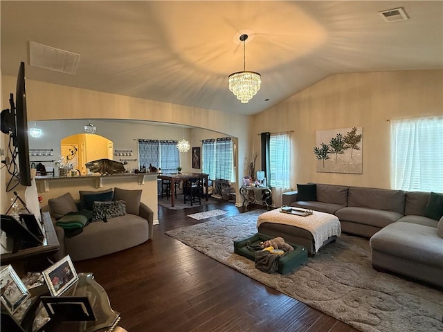 2979 Dungeness Dr, Douglasville, GA 30135 - living room featuring a chandelier, arched walkways, vaulted ceiling, and wood-type flooring