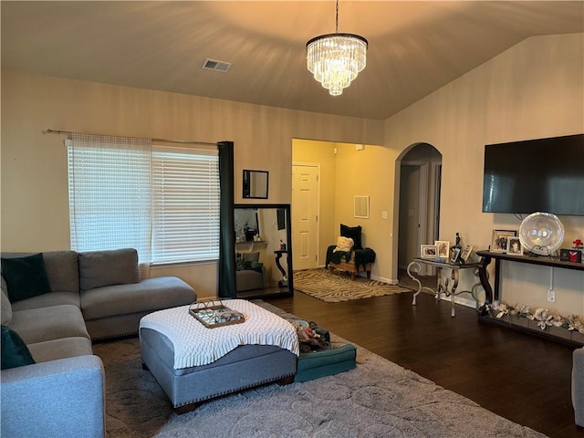 2979 Dungeness Dr, Douglasville, GA 30135 - living area with arched walkways, wood finished floors, a chandelier, and vaulted ceiling