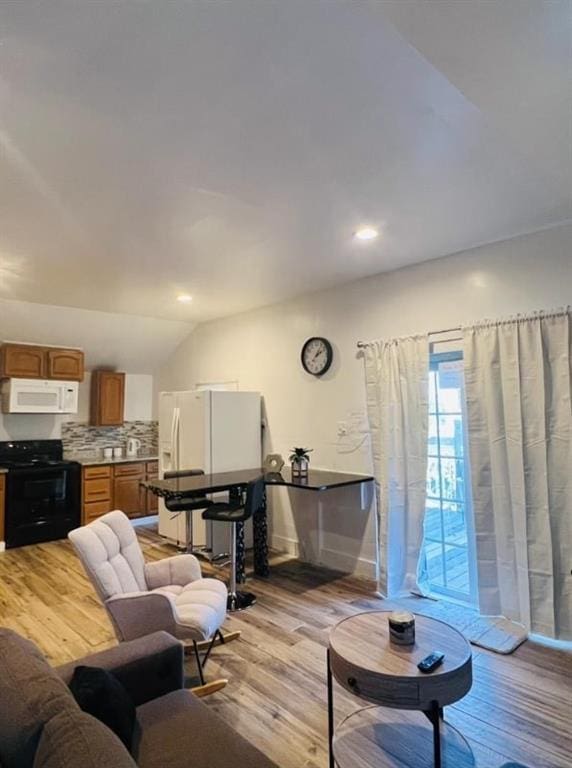 2021 Moody Dr SW, Atlanta, GA 30315 - living area featuring light wood-type flooring, vaulted ceiling, and recessed lighting