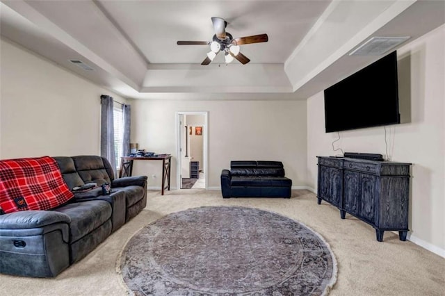 29 Madrid Ave, Newnan, GA 30263 - living area with carpet flooring, a tray ceiling, ceiling fan, and baseboards