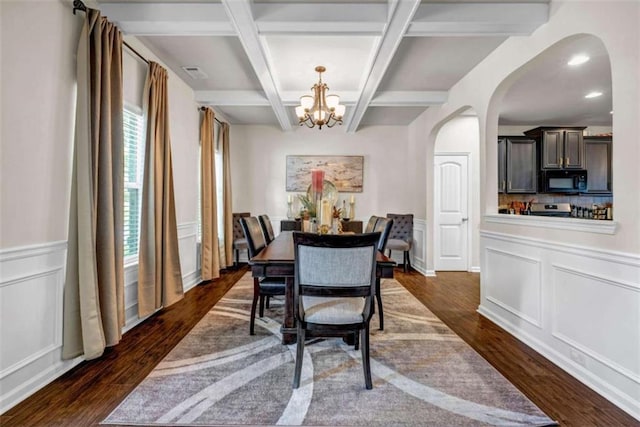 29 Madrid Ave, Newnan, GA 30263 - dining space with arched walkways, a chandelier, dark wood-type flooring, coffered ceiling, and a decorative wall
