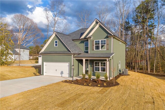 craftsman house with cooling unit, a garage, a front lawn, and covered porch