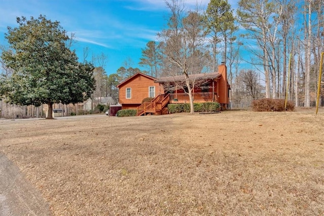 view of front of home featuring a deck and a front yard