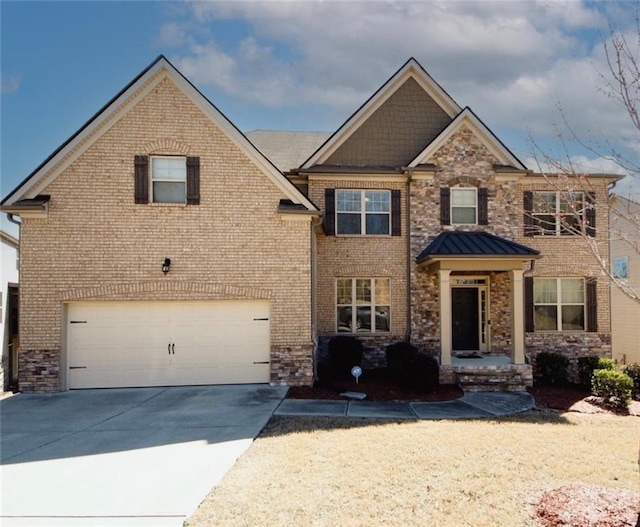 4594 Marching Ln, Fairburn, GA 30213 - view of front facade featuring concrete driveway, stone siding, an attached garage, a standing seam roof, and brick siding