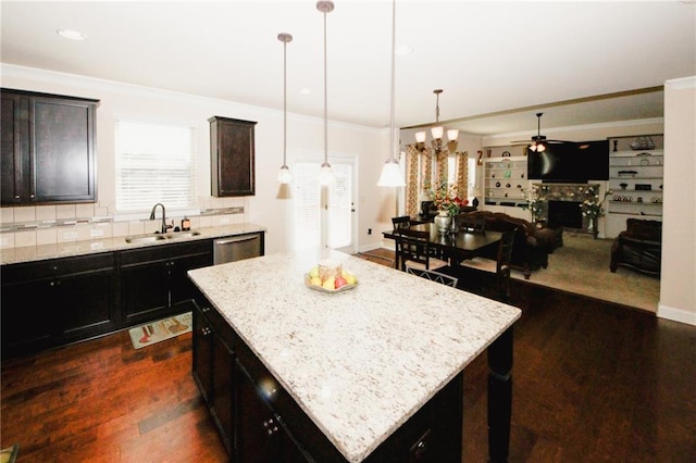 4594 Marching Ln, Fairburn, GA 30213 - kitchen featuring dark wood-type flooring, a sink, a kitchen island, open floor plan, and decorative light fixtures