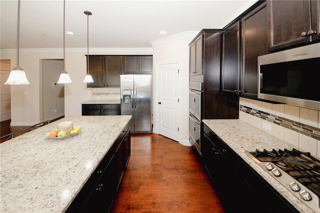 4594 Marching Ln, Fairburn, GA 30213 - kitchen featuring dark brown cabinetry, light stone countertops, appliances with stainless steel finishes, and pendant lighting