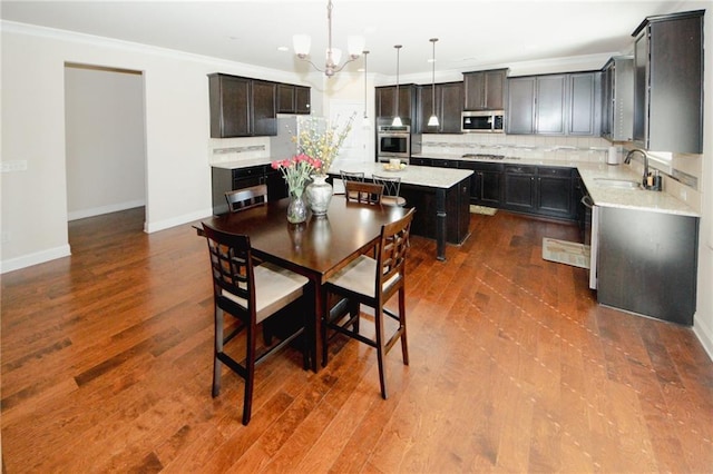 4594 Marching Ln, Fairburn, GA 30213 - dining room with baseboards, ornamental molding, dark wood finished floors, and a notable chandelier