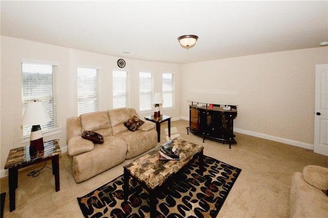 4594 Marching Ln, Fairburn, GA 30213 - living area featuring light carpet, plenty of natural light, and baseboards