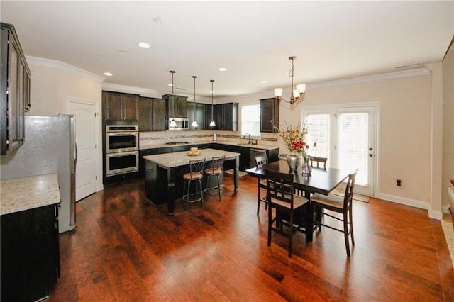 4594 Marching Ln, Fairburn, GA 30213 - dining room featuring ornamental molding, recessed lighting, dark wood finished floors, and a notable chandelier