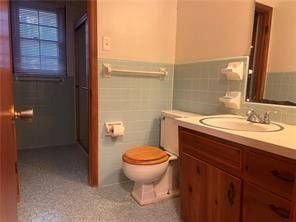 bathroom with toilet and vanity