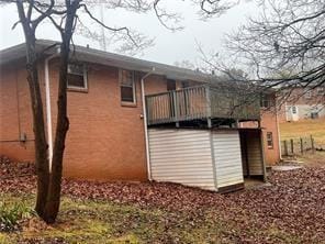 view of side of property featuring a wooden deck