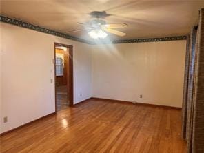 empty room featuring wood-type flooring and ceiling fan