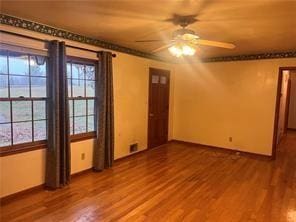 unfurnished room featuring hardwood / wood-style flooring, plenty of natural light, and ceiling fan