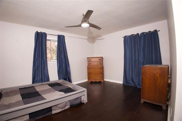 bedroom with ceiling fan and dark hardwood / wood-style floors