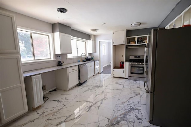 kitchen featuring sink, white cabinetry, and stainless steel appliances