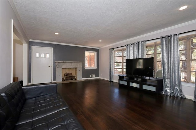 unfurnished living room featuring hardwood / wood-style flooring, crown molding, a premium fireplace, and a textured ceiling