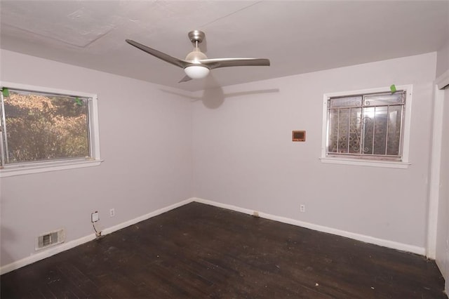 empty room featuring ceiling fan and dark hardwood / wood-style flooring