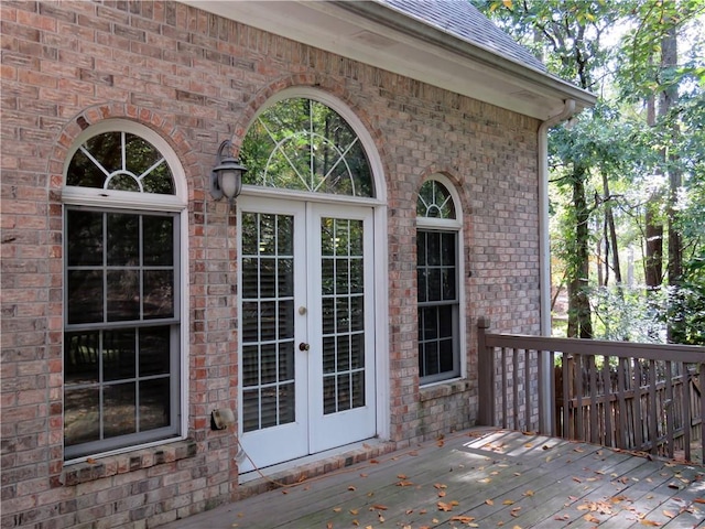 doorway to property with a wooden deck and french doors