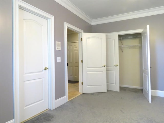 unfurnished bedroom with a closet, ornamental molding, and light colored carpet