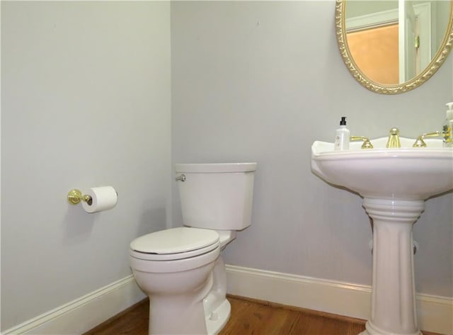 bathroom with toilet and hardwood / wood-style flooring