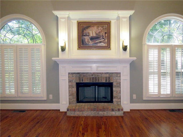 room details with a brick fireplace and hardwood / wood-style flooring