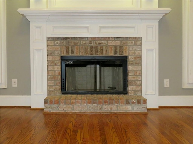 interior details featuring wood-type flooring and a fireplace