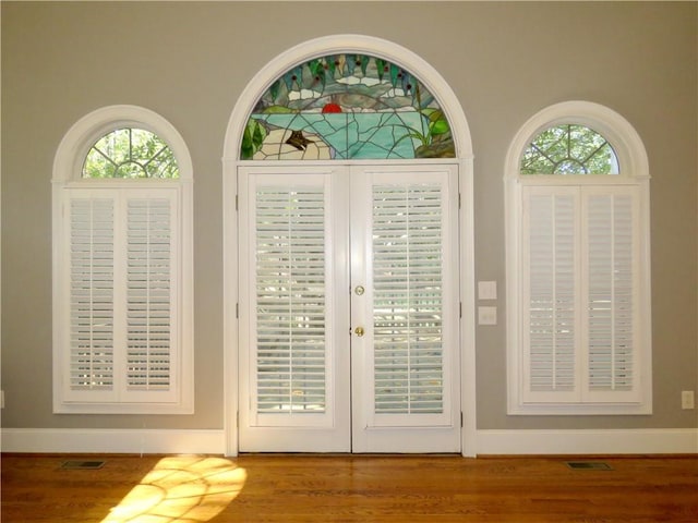 doorway to outside with hardwood / wood-style flooring and a wealth of natural light