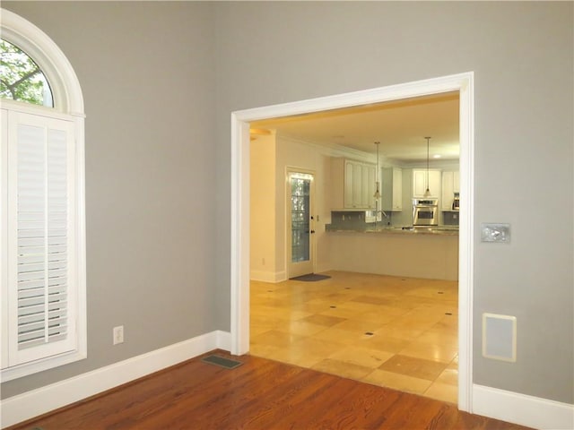 interior space featuring crown molding and light wood-type flooring