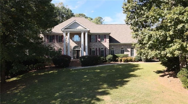 neoclassical home with a front lawn