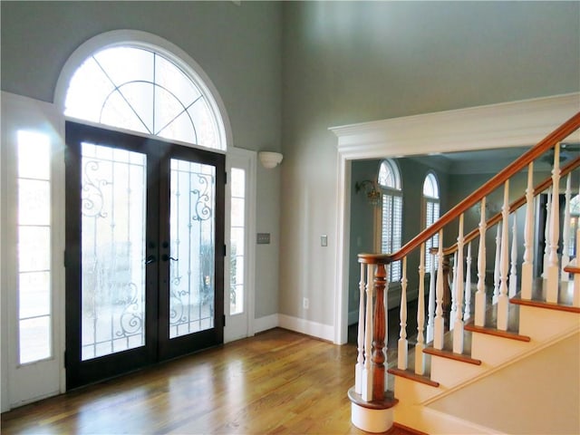 entryway featuring french doors, wood-type flooring, and a wealth of natural light