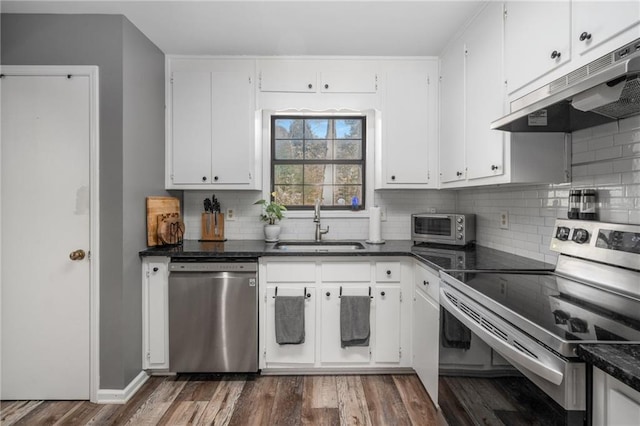 kitchen with dark hardwood / wood-style floors, sink, stainless steel appliances, and white cabinetry