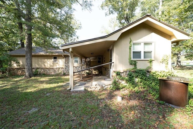 rear view of property featuring a yard