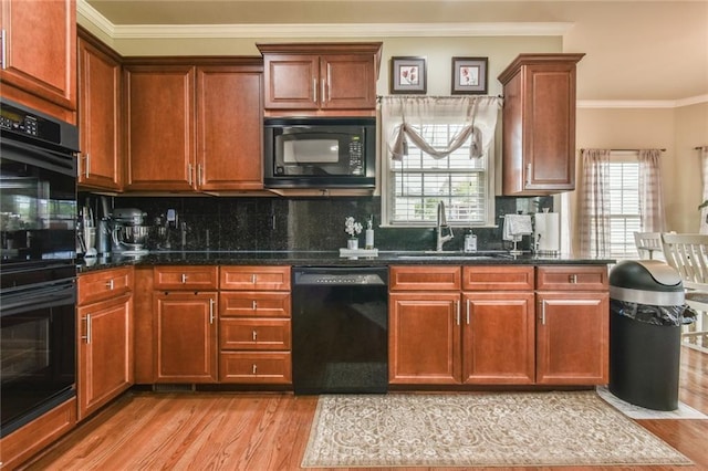 2727 Lost Mill Trce, Buford, GA 30519 - kitchen with decorative backsplash, crown molding, light wood-style flooring, a sink, and black appliances
