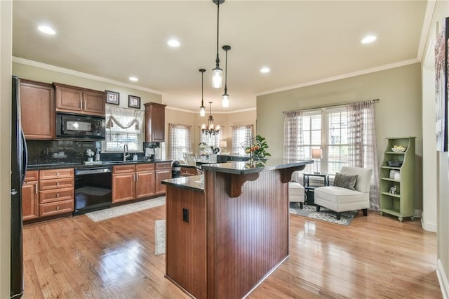2727 Lost Mill Trce, Buford, GA 30519 - kitchen with ornamental molding, black appliances, a kitchen breakfast bar, and a sink