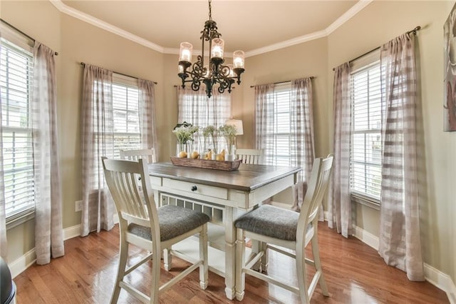 2727 Lost Mill Trce, Buford, GA 30519 - dining room with ornamental molding, a healthy amount of sunlight, a notable chandelier, and baseboards