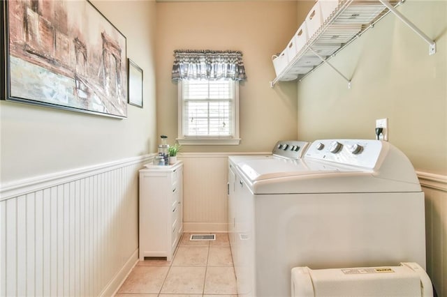 2727 Lost Mill Trce, Buford, GA 30519 - laundry room with light tile patterned floors, visible vents, a wainscoted wall, separate washer and dryer, and laundry area