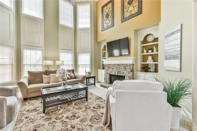 2727 Lost Mill Trce, Buford, GA 30519 - living area featuring a fireplace, a wealth of natural light, and a high ceiling